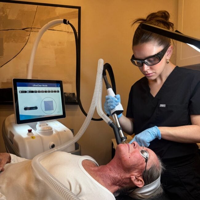 A female provider using the UltraClear on a patient's face