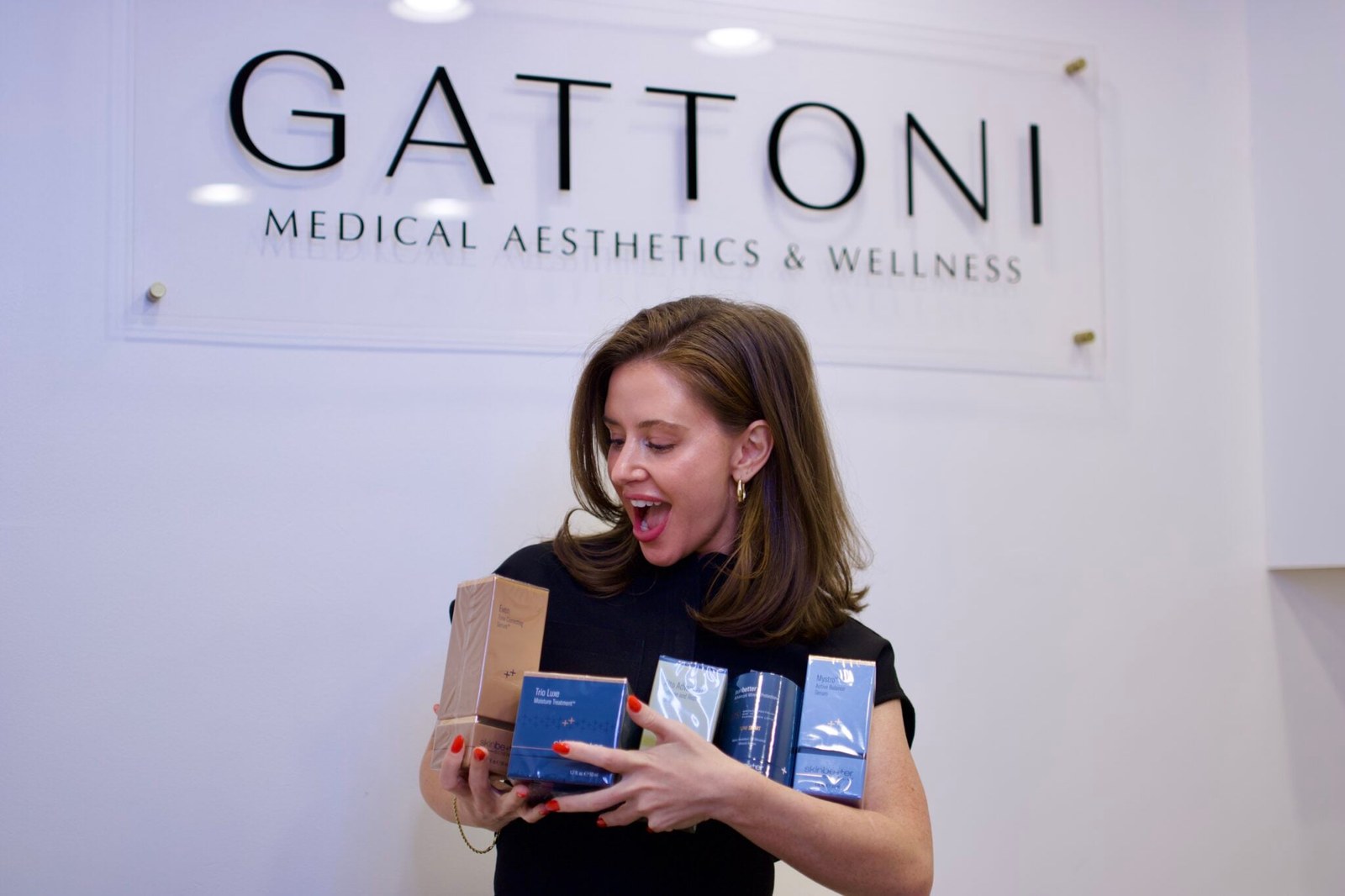 GATTONI Medical Aesthetics team member holding skincare products